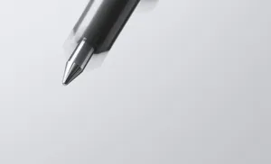 Close-up detail of smooth metal gel pen tip and dark barrel, precise writing performance.