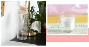 Transparent water bottle and glass candle decorated with holographic cartoon stickers for daily use.