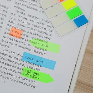 Close-up detail of colorful PET index sticky notes and page markers used on a book page.