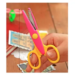 DIY craft scissors with zigzag edge and pink yellow handle for photo album scrapbooking.