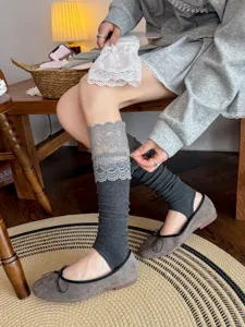 Detailed shot of grey lace stirrup leg warmers sweet lolita knit slouch socks for autumn