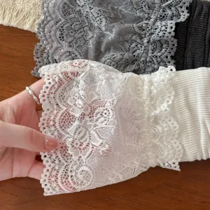 Close-up detail of sweet Lolita lace leg warmers showing exquisite floral pattern texture.