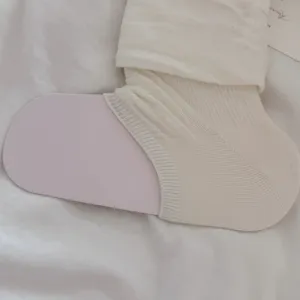 Korean style cream white slouchy leg warmer knit detail, soft fabric texture close up shot.
