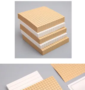 Detailed view of grid sticky notes memo pads, kraft paper and white paper stack for office.