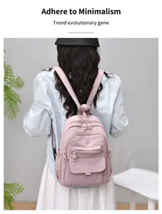 Back view detail of a lightweight pink nylon casual backpack for women, travel and daily use.