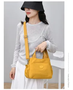 Detailed view of the yellow casual shoulder tote bag showcasing multiple pockets and durable straps.