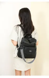 Detail view of retro soft leather women's backpack with ethnic wide strap and multi-pocket design.