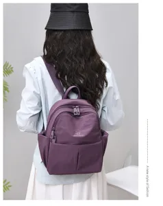 Detail view of the purple casual backpack featuring multiple storage pockets and design.