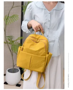 Stylish women's yellow backpack, casual large capacity travel water-resistant school bag.