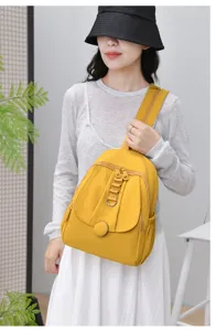 Close-up detail of stylish yellow multi-functional women chest bag worn outdoors or commuting.