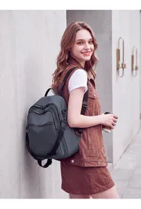 Stylish dark grey women's backpack detail shot, perfect for daily commute and casual travel.