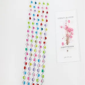 Close up of colorful heart shaped acrylic rhinestone stickers for DIY crafts and album decor.