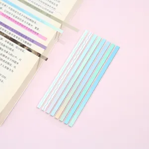 Closeup detail view of Morandi color sticky notes transparent index tabs on pink desk background.