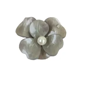 Detailed view of grey tie-dye resin flower hair claw clip with pearl center and rhinestone accent.