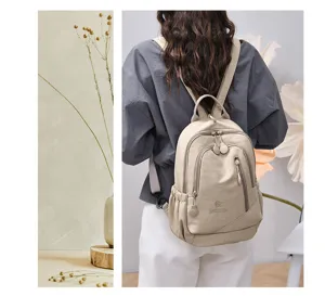Detailed view of a stylish casual nylon backpack in beige, featuring multi compartments.
