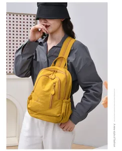Casual yellow nylon backpack for women, lightweight multi-pocket daily commuting travel bag.
