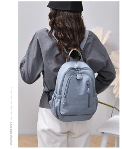 Casual nylon backpack for women, lightweight multi-pocket commuter travel daypack light blue.