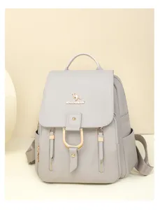 Detail view of the soft leather women backpack in light grey with stylish metal buckle and zipper.
