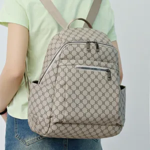 Detailed view of stylish casual backpack with monogram pattern, large capacity and dual straps.