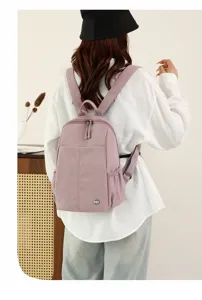 Detailed view of casual nylon backpack in light purple, showing back wear and fabric texture.
