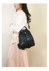 Stylish women's black leather backpack detail, retro monogram commuting schoolbag daily use.