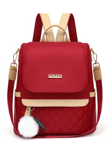 Red quilted oxford cloth backpack for women with stylish beige trim and fluffy pom-pom.