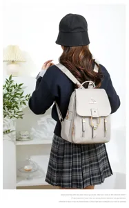 Detail view of stylish soft leather backpack with metal kangaroo logo and pockets.