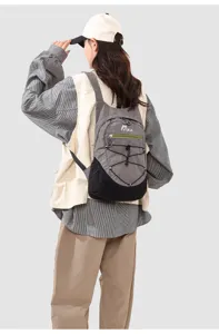 Detail view of lightweight folding outdoor backpack worn by model, casual travel bag.