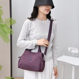 Casual nylon shoulder bag for women, large capacity commuter tote handbag with strap.