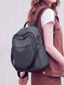 Stylish women's backpack in dark grey, featuring multi-pocket design for daily commute and travel.