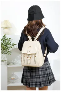 Detailed view of women soft leather backpack in beige showcasing metal hardware and clean minimal aesthetic.