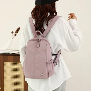 Casual nylon backpack for women, lightweight large capacity travel bag, stylish commuting bag.