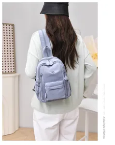 Detail view of the lightweight nylon mini backpack for women, multi-pocket casual dual-use bag.