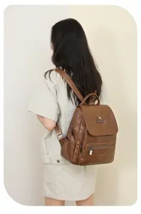 Detail view of stylish brown leather casual backpack with metal zippers and kangaroo logo.