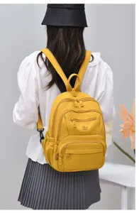 Waterproof nylon backpack detail, multi-pocket casual school bag for women daily commute.