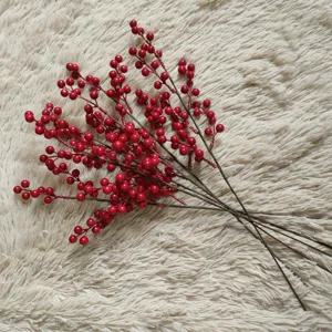 Artificial red berry branch close up, festive floral decor detail shot for holiday.
