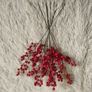 Detailed view of artificial red berry branches, perfect for holiday home decoration.