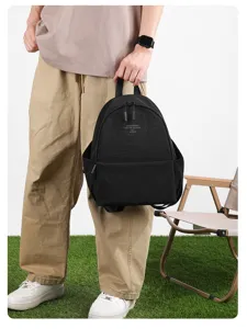 Detailed view of casual black washed nylon backpack, lightweight daily travel school bag.
