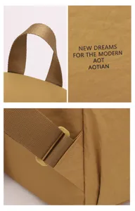 Washed nylon backpack detail showing durable handle, logo print, and adjustable straps.