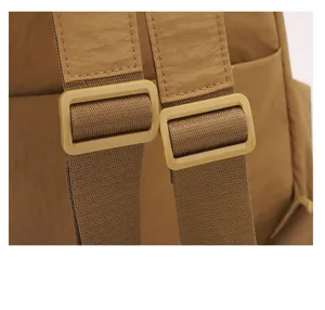 Washed nylon backpack shoulder strap and sturdy plastic adjustment buckle detail close