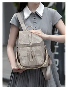 Details of the retro washed canvas backpack with ethnic woven strap, tassel, and large capacity.