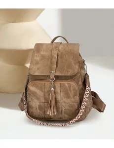 Vintage washed fabric backpack for women with ethnic woven strap and tassel, large capacity.