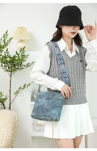 Detail shot of soft leather shoulder bag with wide geometric strap and stylish design.