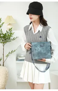 Stylish soft leather bucket shoulder bag for women with wide geometric patterned strap daily use.