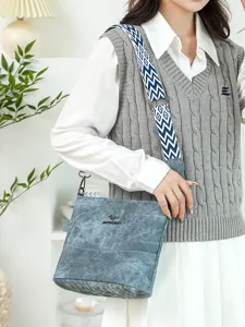 Stylish soft leather bucket shoulder bag for women featuring wide geometric strap, main view.