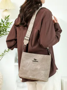 Fashionable women's shoulder messenger bag with wide woven strap, large capacity soft leather.