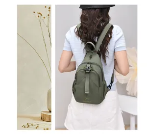 Detail view of lightweight nylon backpack in green, featuring multi-compartment design.