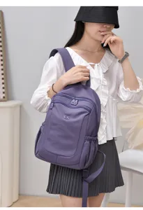 Stylish purple nylon backpack for women, lightweight waterproof school bag for daily commute.
