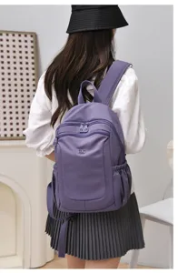 Casual purple nylon backpack for women, large capacity daily commuter school bag.