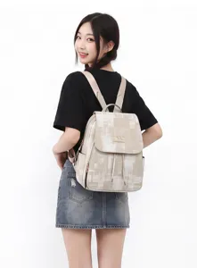 Beige washed denim pattern backpack detail, drawstring flap design, large capacity casual bag.